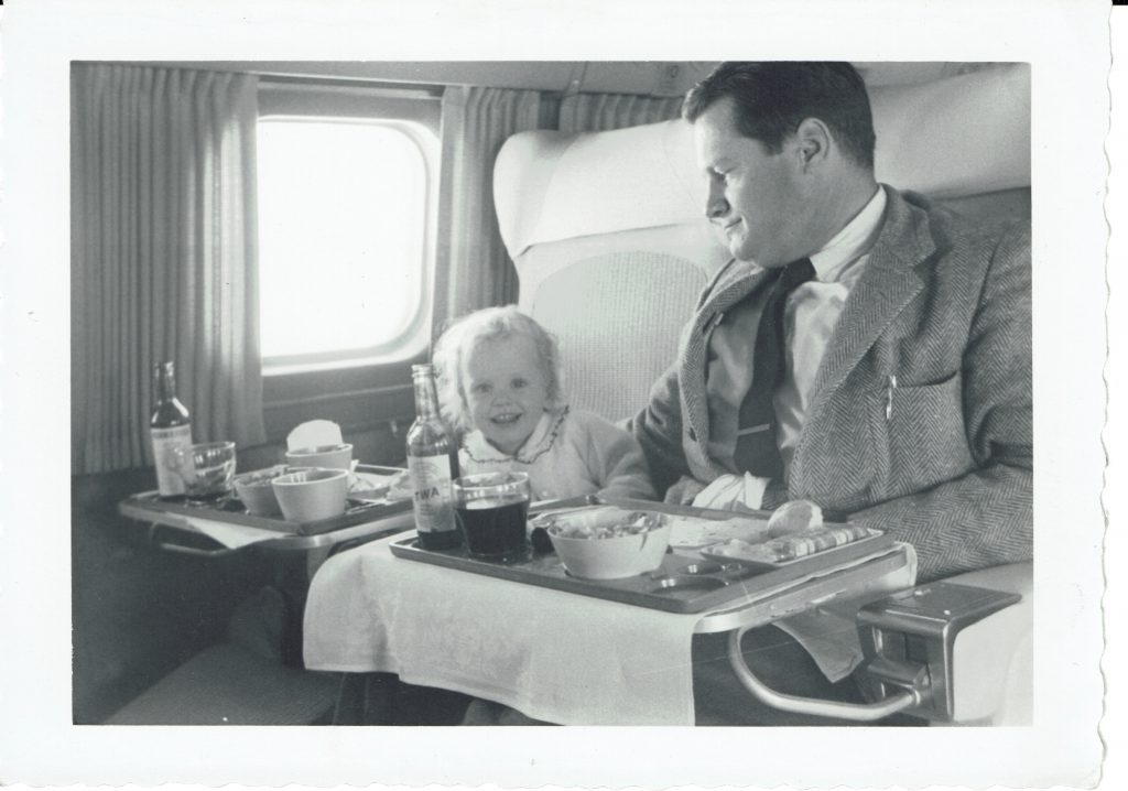 Joyce McGreevy, who is now decluttering to become a digital nomad, with Wallace McGreevy on a TWA flight in 1958. Image @ McGreevy Family collection.