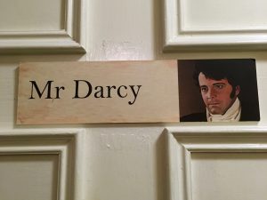 A Mr Darcy sign at the Jane Austen Centre, Bath, England, reflects the wit, wisdom, and wordplay of signage in public spaces. Image © Joyce McGreevy