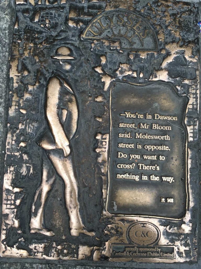 A pavement sign in Dublin, Ireland commemorating James Joyce's Ulysses reflects the wordplay, wit, and wisdom of signage in public spaces. Image © Joyce McGreevy