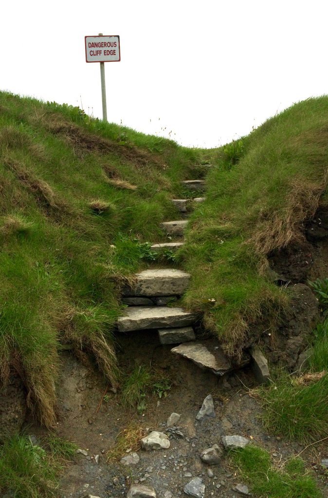 A danger sign in Lahinch, Ireland lends drama to the wit and wisdom of signage in public spaces. Image © Joyce McGreevy