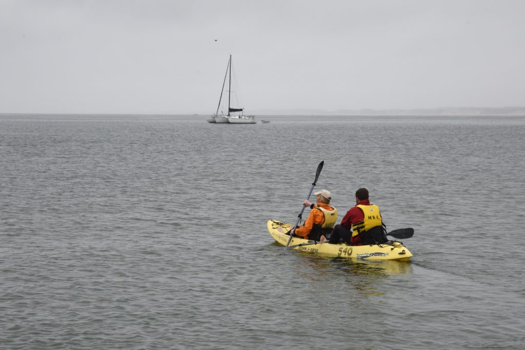 Kayak with two people in the Pacific Ocean after being educated about the California sea otter for nature watch to protect the otters. (Image © Meredith Mullins.)