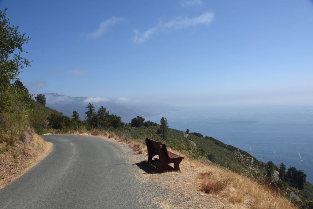 A bench by the road at the Big Sur New Camaldoli Hermitage, a place for seeking silence and challenging the cultural traditions of Labor Day. (Image © Meredith Mullins.)