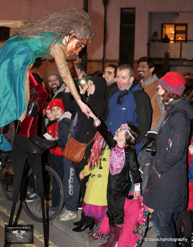 A Macnas street performer and costumed girl share an "aha moment" in Ireland, likely birthplace of Halloween around the world. (Image © Darach Glennon/ Darachphotography)