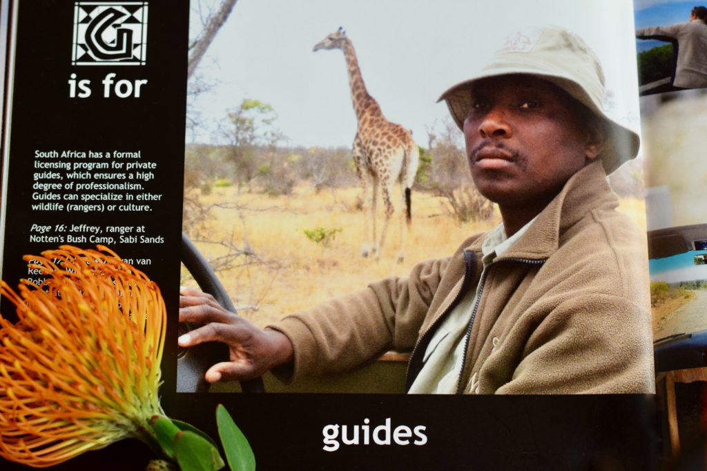 A travel book with portrait of Jeffrey, a safari guide at Notten’s Bush Camp, South Africa pays tribute to the way local guides provide cultural context. Image ©Julie Cason