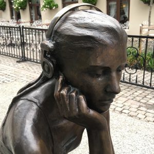A detail from Marit Krogh's "Seated Girl with Headphones" in Oslo, Norway reflect inner discoveries and urban peace and quiet (© Joyce McGreevy)