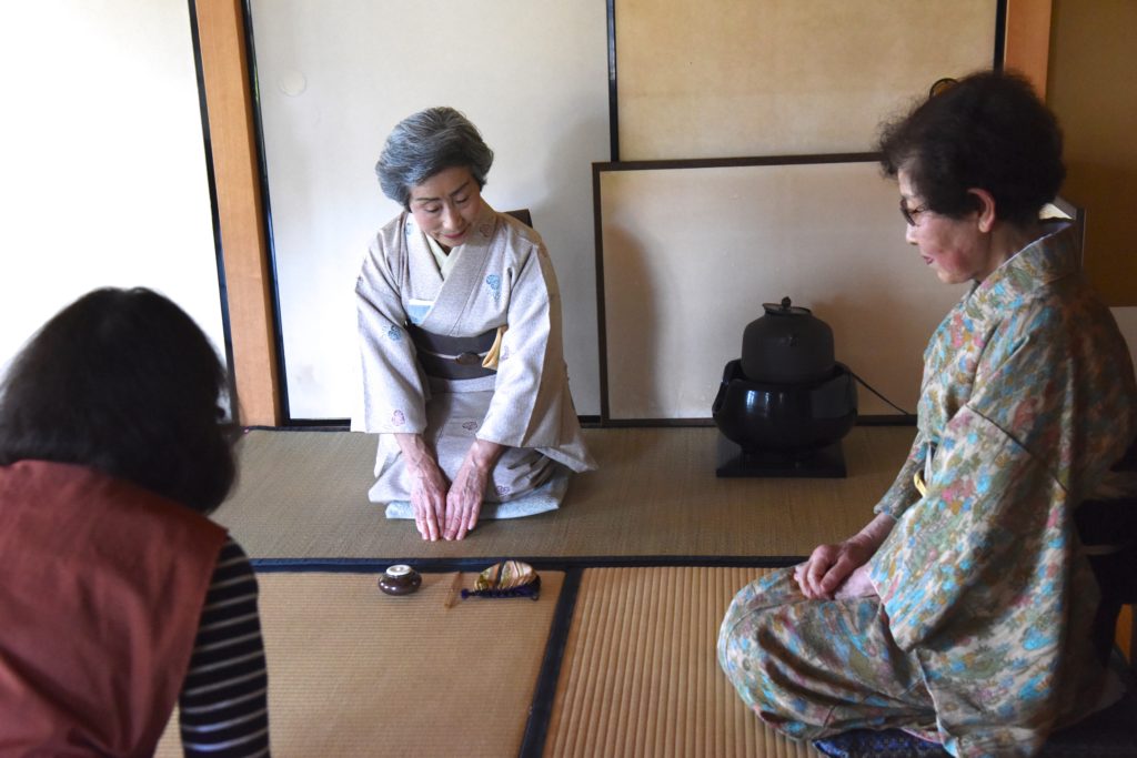 Japanese woman displays the utensils of the Japanese tea ceremony, showing the cultural traditions of Japan. (Image © Meredith Mullins.)