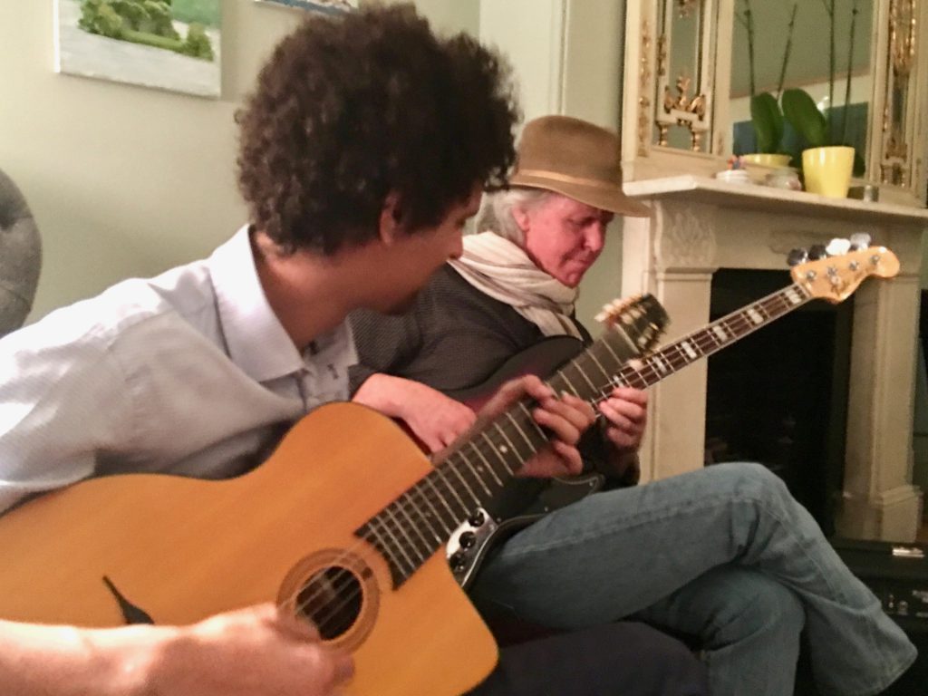 Kieran O'Donnell and Rick Chelew play guitar together, carrying on the Irish tradition of sharing songs, stories, and poems. (Image © Joyce McGreevy)