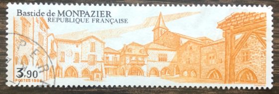 A postage stamp showing Monpazier France in gold, showing that postage stamps can reveal the cultural heritage and traditions of a country. (Image © DMT.)