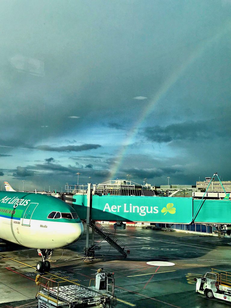 A rainbow above Aer Lingus jets at Dublin International Airport inspires wanderlust for a return visit to Ireland. (Image © Carolyn McGreevy)