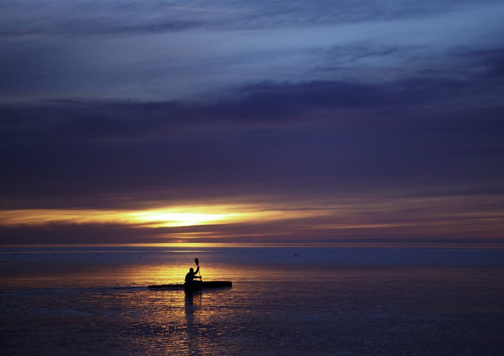 A kayaker savors an aha moment at sunset in Aarhus, where the 2017 European Capital of Culture will celebrate community connection to nature. (Image © Anders Hede/VisitAarhus)