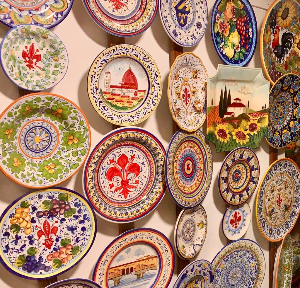 Ceramic plates in Florence, Italy showcase images associated with Italian and Florentine cultural traditions. (Image © Joyce McGreevy)