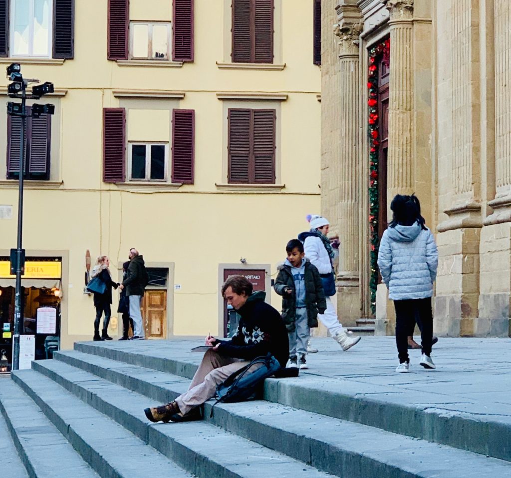 A young man sketching as a boy looks on inspires an aha moment about everyday Italian rituals in Florence. (Image © Joyce McGreevy)