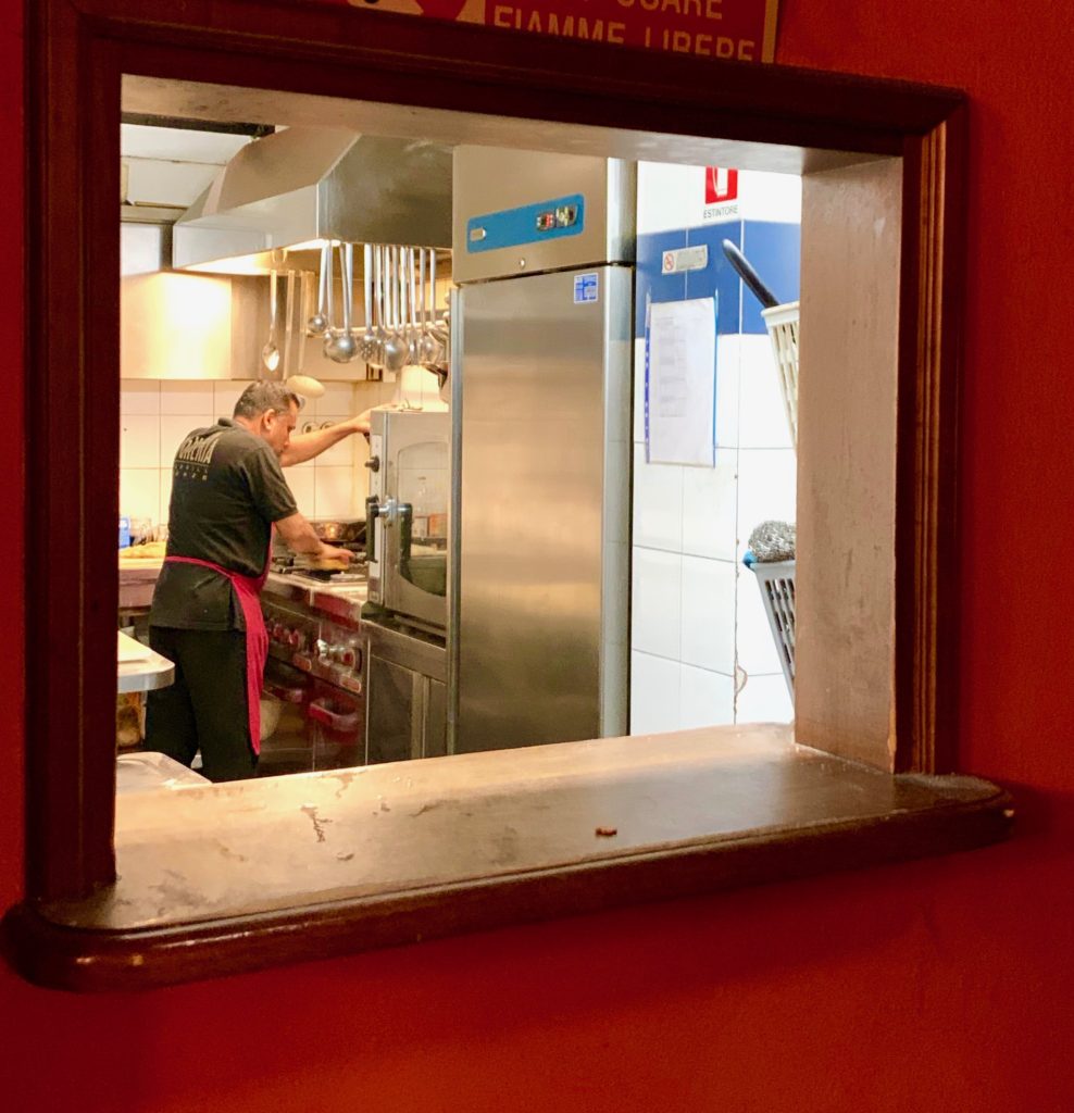 A man cleaning a restaurant kitchen in Florence, Italy inspires an aha moment about life's little rituals. (Image © Joyce McGreevy)