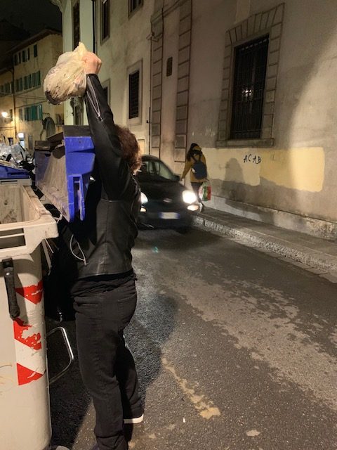 A woman taking out the garbage in Florence, Italy inspires an aha moment about everyday life and life's little rituals. (Image © Victoria Lyons)