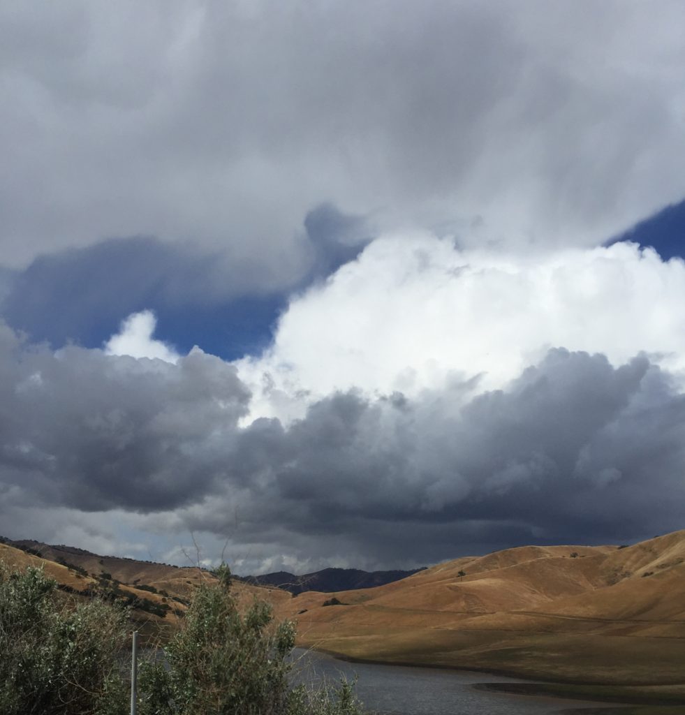 Storm clouds, cumulonimbus, above a hill, cloud watching while traveling the world. (Image © DMT.)