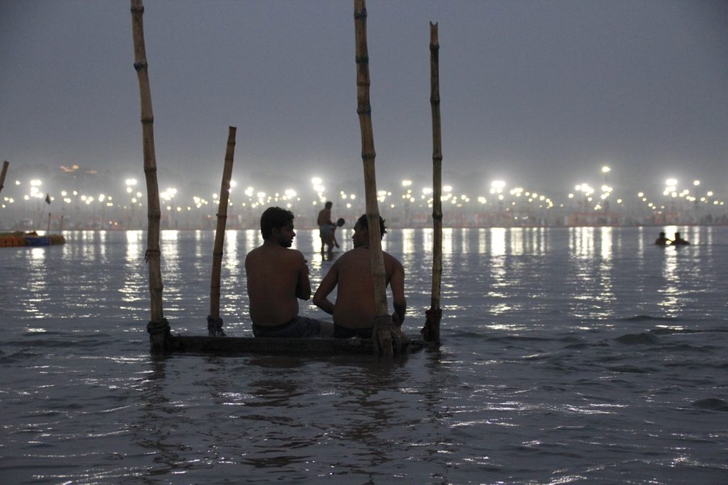 Night shot of bathers at the 2019 Kumbh Mela in Prayagraj (Allahabad), India, one of the amazing places in the world. (Image © René Martinez.)