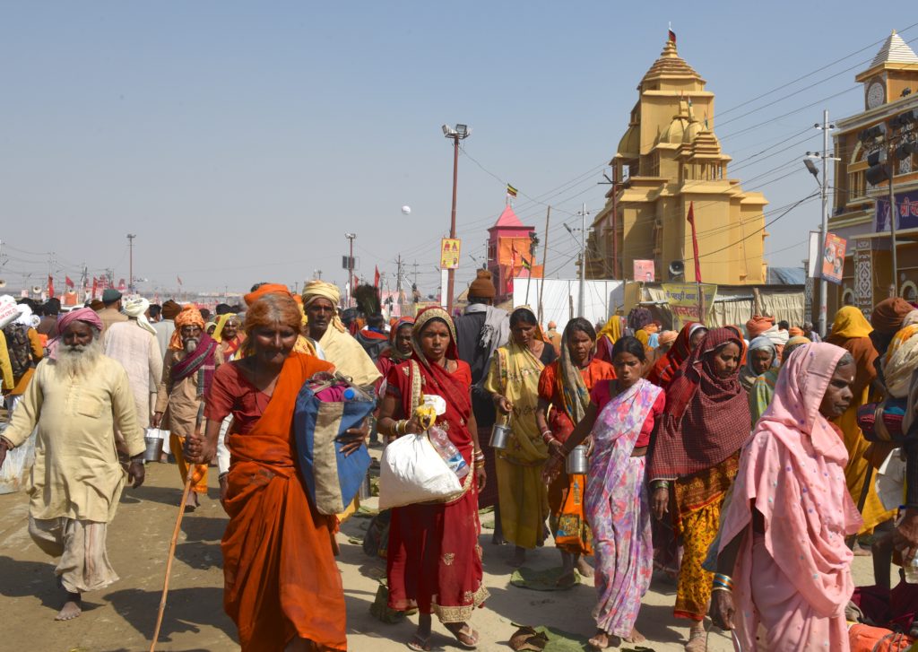 Pilgrims on the main street of the 2019 Ardh Kumbh Mela in Praygraj, India, one of the amazing places in the world. (Image © Meredith Mullins.)