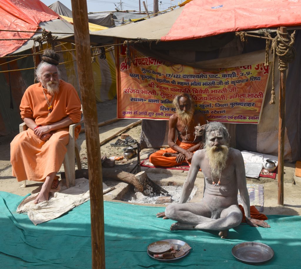 Three sadhus at the 2019 Ardh Kumbh Mela in Prayagraj, India, one of the amazing places in the world. (Image © Meredith Mullins.)