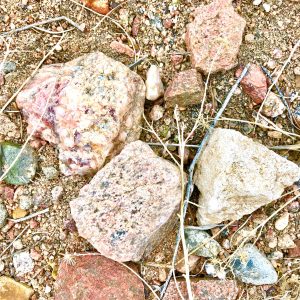Colorful rocks in soil show why Santa Fe, New Mexico inspires wanderlust. (Image © Joyce McGreevy)