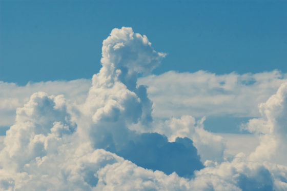 Animal shaped cloud resembling a bear, cloud watching while traveling the world. (Image © Robert Ax/iStock.)