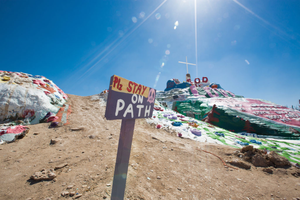 Salvation Mountain, California, one of the roadside signs and roadside attractions that encourage the art of travel. (Image © iStock/Steven Kriemadis.)