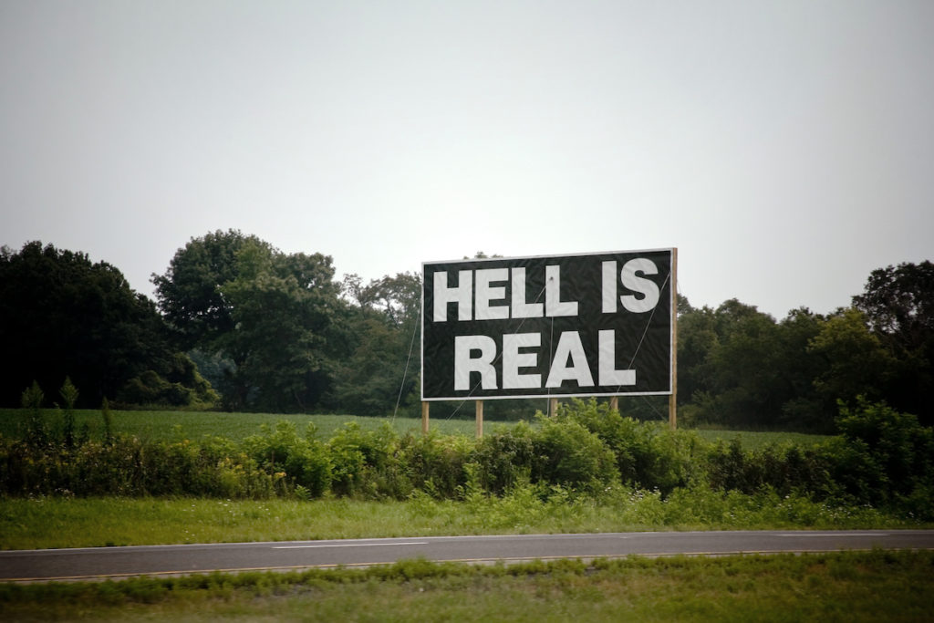Hell Is Real! roadside sign encouraging the art of travel. (Image © iStock/tacojim.)