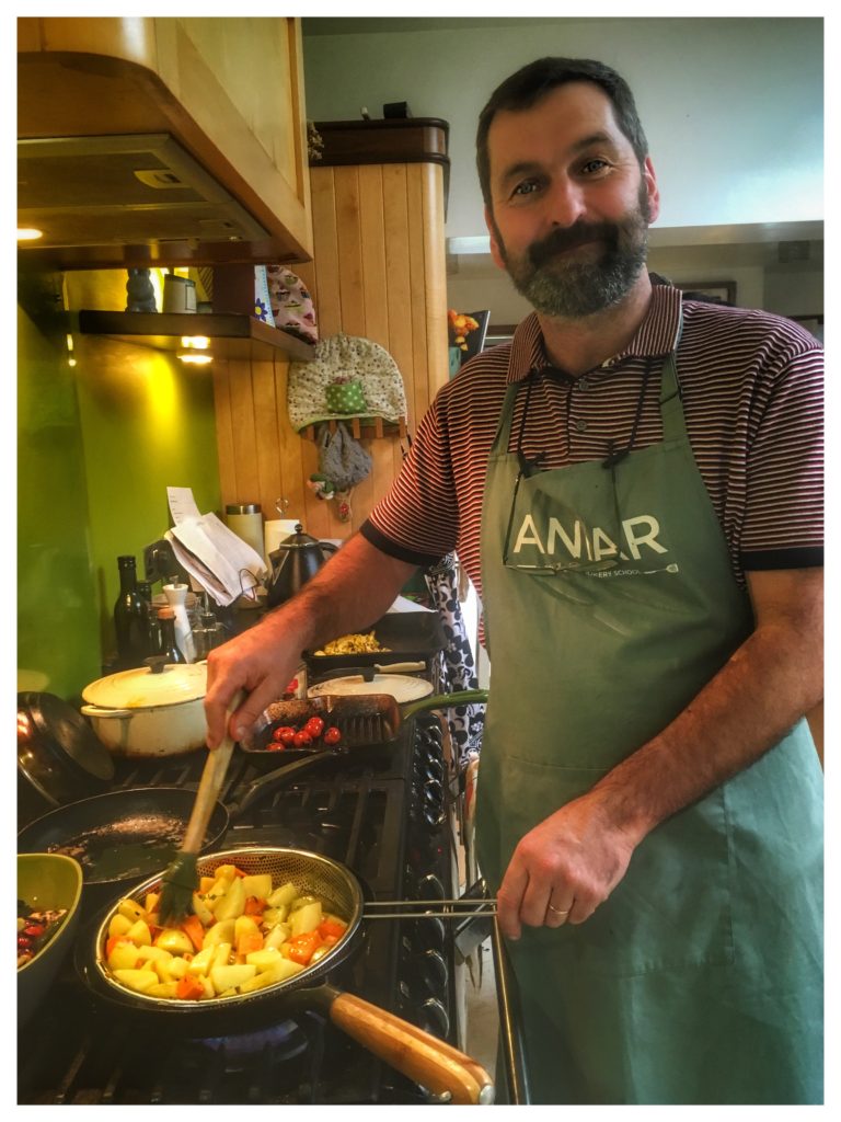 A man cooking at home in Galway, Ireland evokes the way Ireland’s culinary renaissance has dispelled stereotypes about Irish cuisine. (Image © Joyce McGreevy)