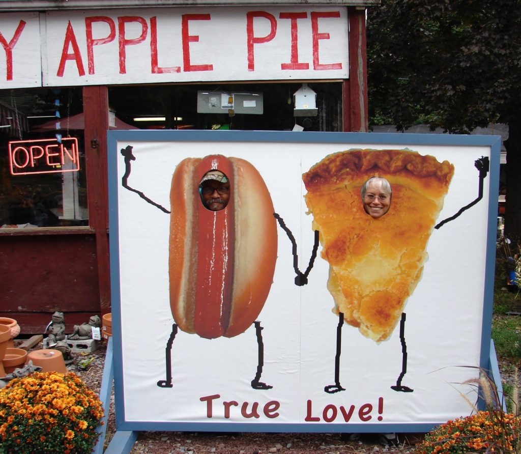 A roadside sign with a burger and apple pie, encouraging the art of travel. (Image © DMT.)