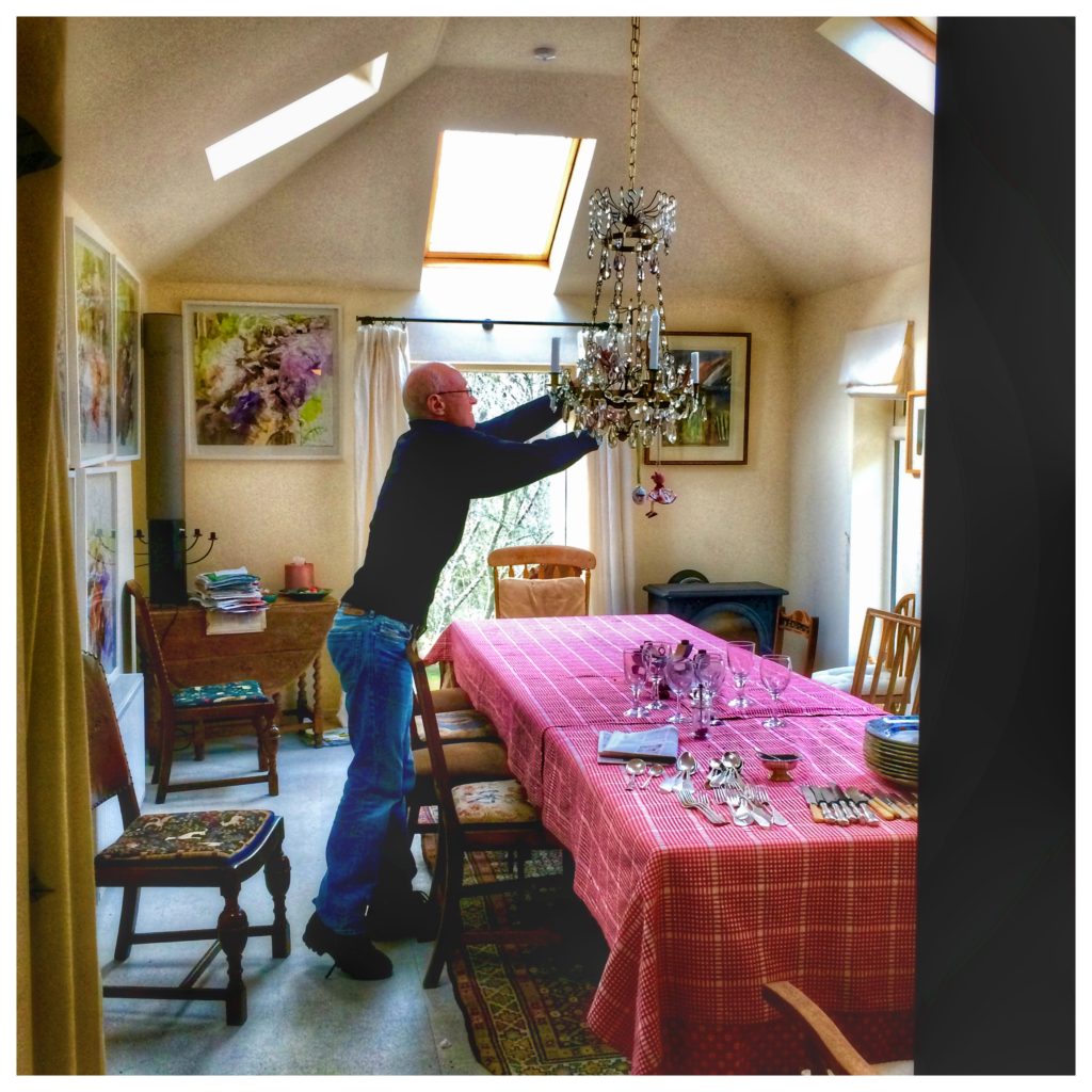 A man adjusting a dining room chandelier in Glendalough suggests that Ireland’s culinary renaissance has dispelled stereotypes about Irish cuisine. (Image © Joyce McGreevy)