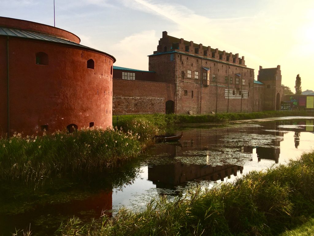 A tower at Malmöhus Castle, Malmö, Sweden inspires travel tips about visiting underrated cities when traveling full time. (Image © Joyce McGreevy)