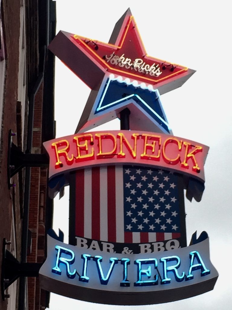 Redneck Riviera roadside sign, encouraging the art of travel. (Image © Lauren Gezurian-Amlani.)