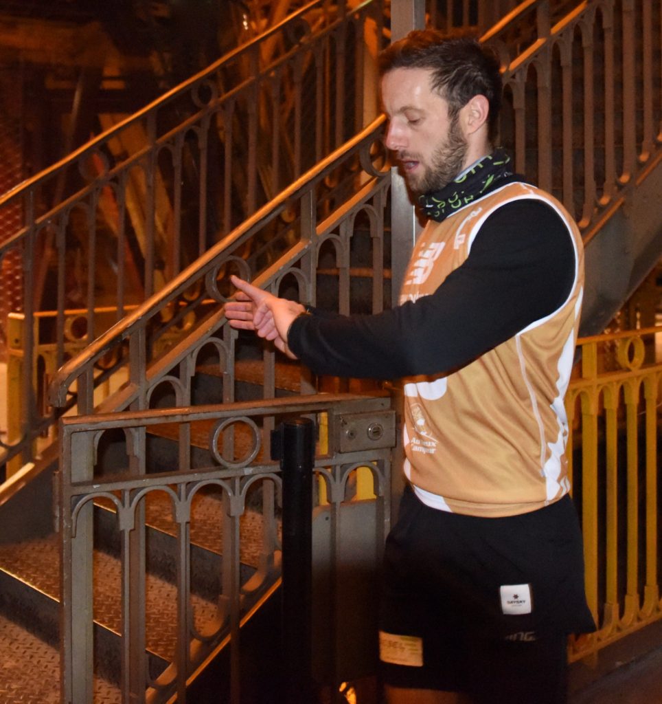 Runner checking watch at the 2019 Eiffel Tower Vertical race at one of the most amazing places on earth. (Image © Meredith Mullins.)