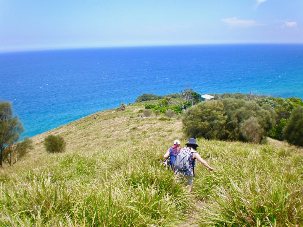 Hikers above Royal National Park in New South Wales, Australia, inspire a writer’s travel tips about enjoying simple pleasures while traveling full time. (Image © Joyce McGreevy)