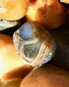 Agates and other pebbles from Lincoln City beach shine like glass floats, part of a cultural tradition of the Oregon coast. (Image © Carolyn McGreevy)