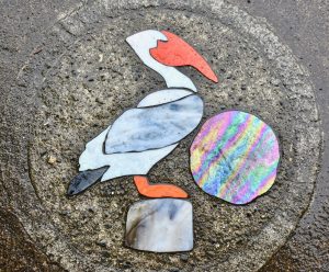 Glass art in the pavement of a Lincoln City street reflects a cultural tradition of the Oregon coast. (Image © Joyce McGreevy)