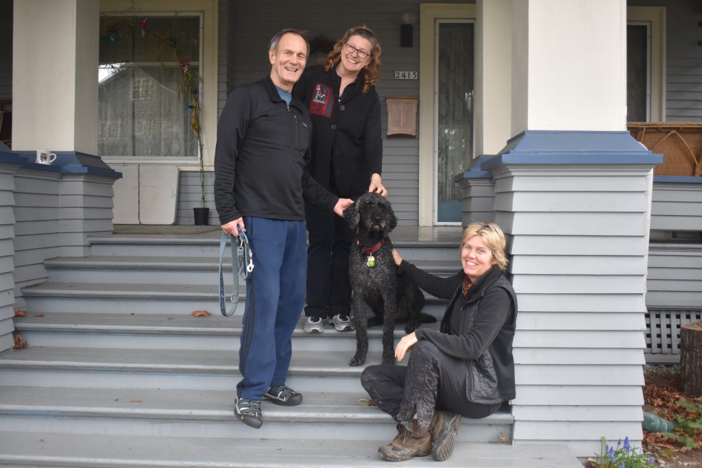 Neighbors and dog visit with creative thinker Meg Vogt on a porch in Sullivan Gulch, Portland, Oregon. (Image © Joyce McGreevy)