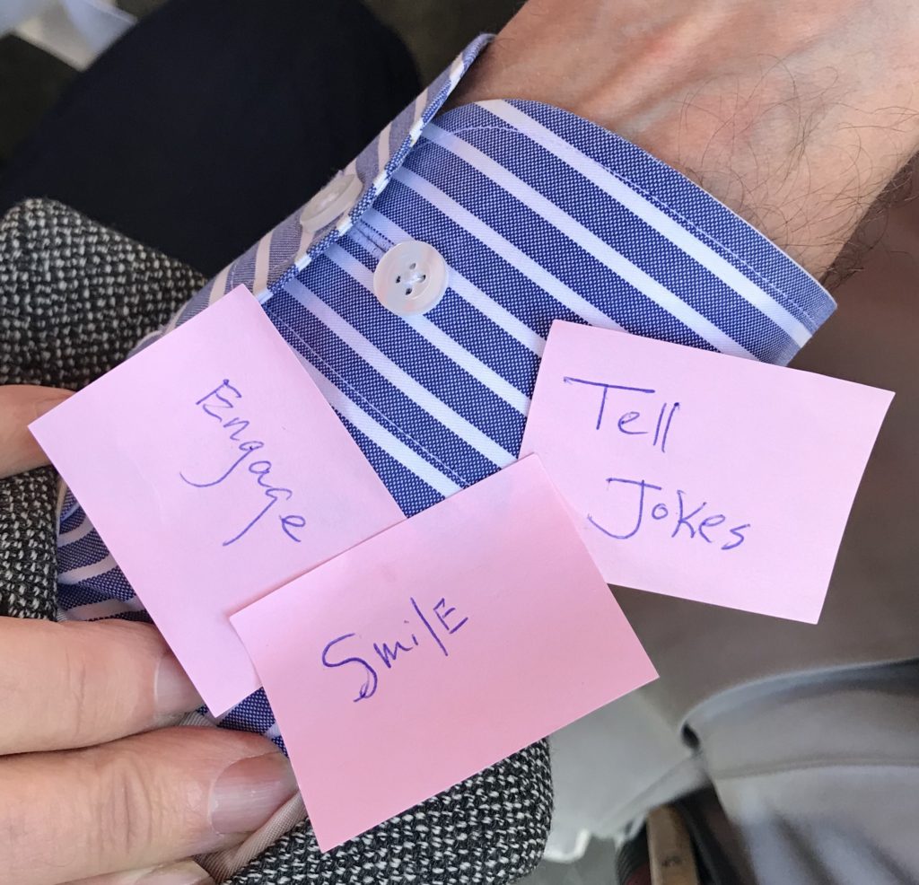 A shirt cuff with post-it notes, showing the idiom off the cuff, one of the popular proverbs and sayings in the English language. (Image © Meredith Mullins.)