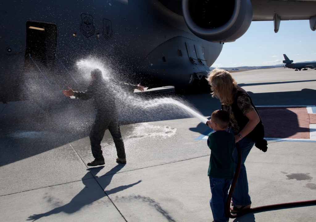 People playing with water by an airplane remind the author of aviation traditions and innovation. [Image public domain]