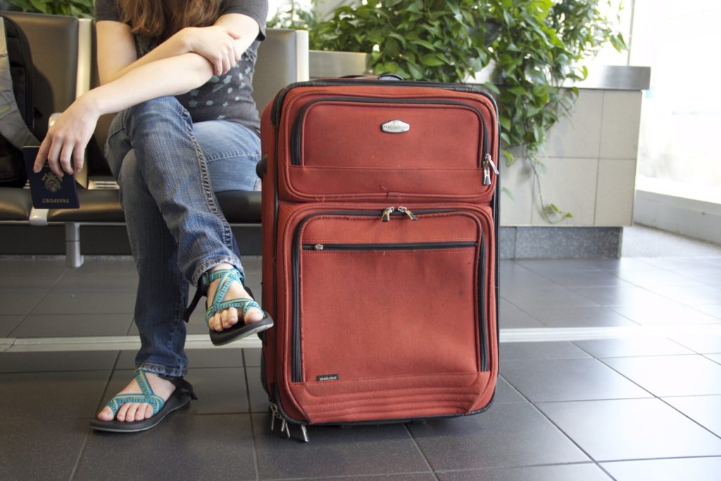 A figure with suitcase at an airport evokes the need for aviation innovations and creative problem solving. [Image public domain]