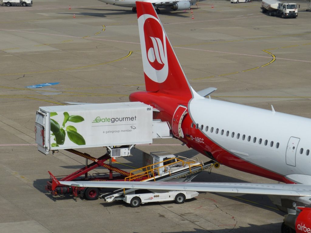 A food truck and commercial airplane on a runway remind the author of the need for aviation innovations and creative problem solving. [Image public domain]