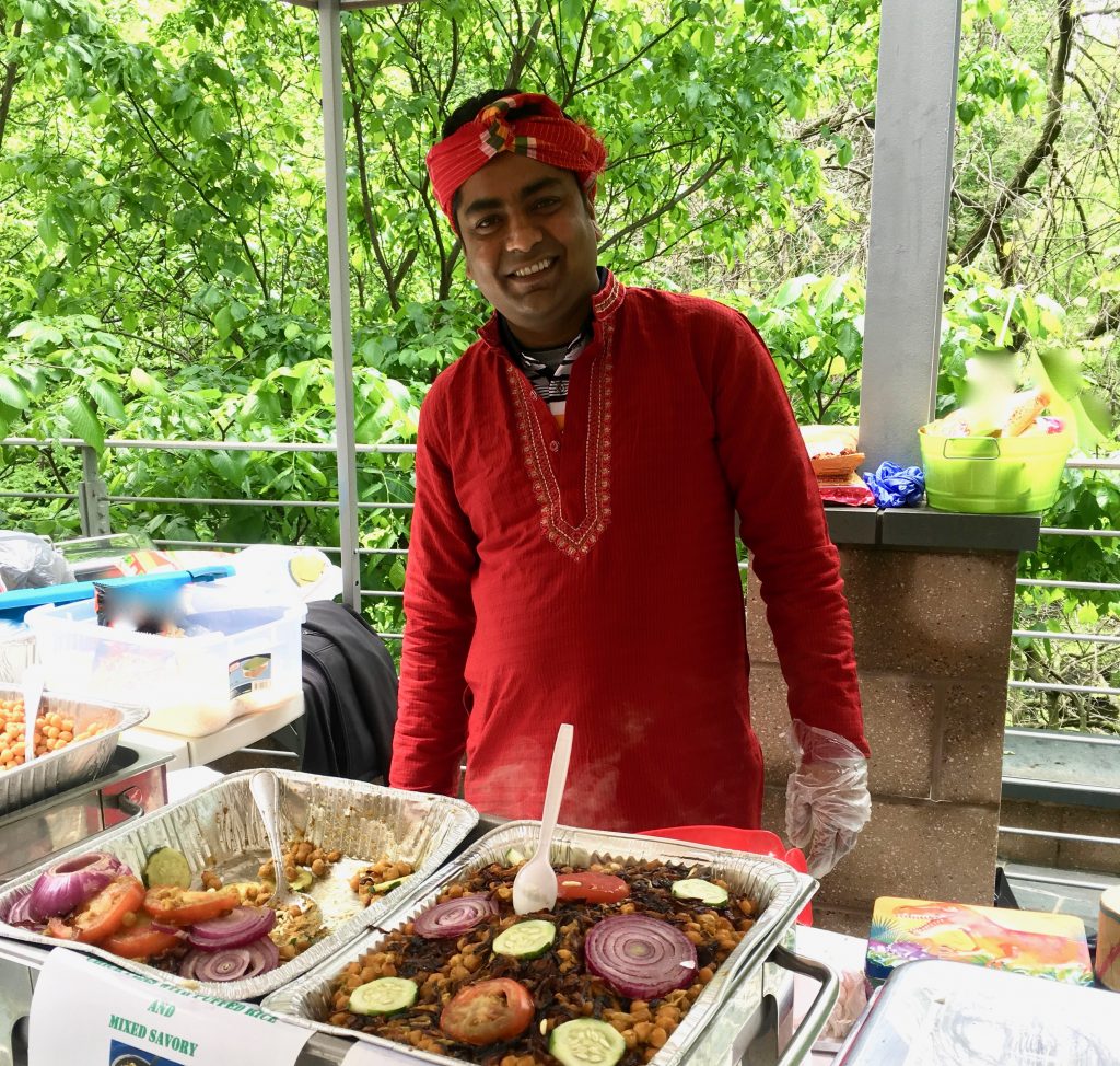 A volunteer at the Embassy of Bangladesh in Washington, DC presents traditional cuisine as part of Passport DC, a celebration of crossing cultures. (Image © Joyce McGreevy)