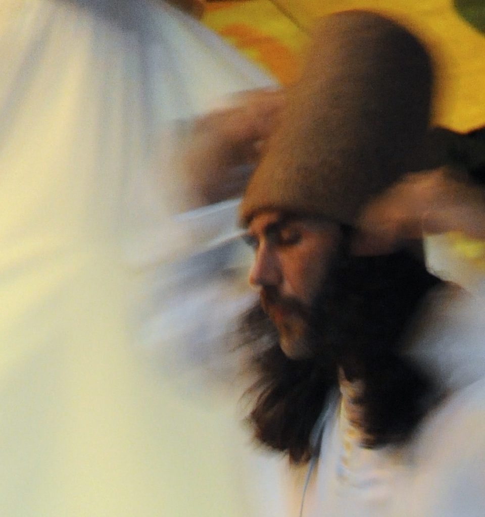 Close-up of the face of one of the whirling dervishes during the dance in the Sufi Sema ceremony in Istanbul. (Image © Meredith Mullins)