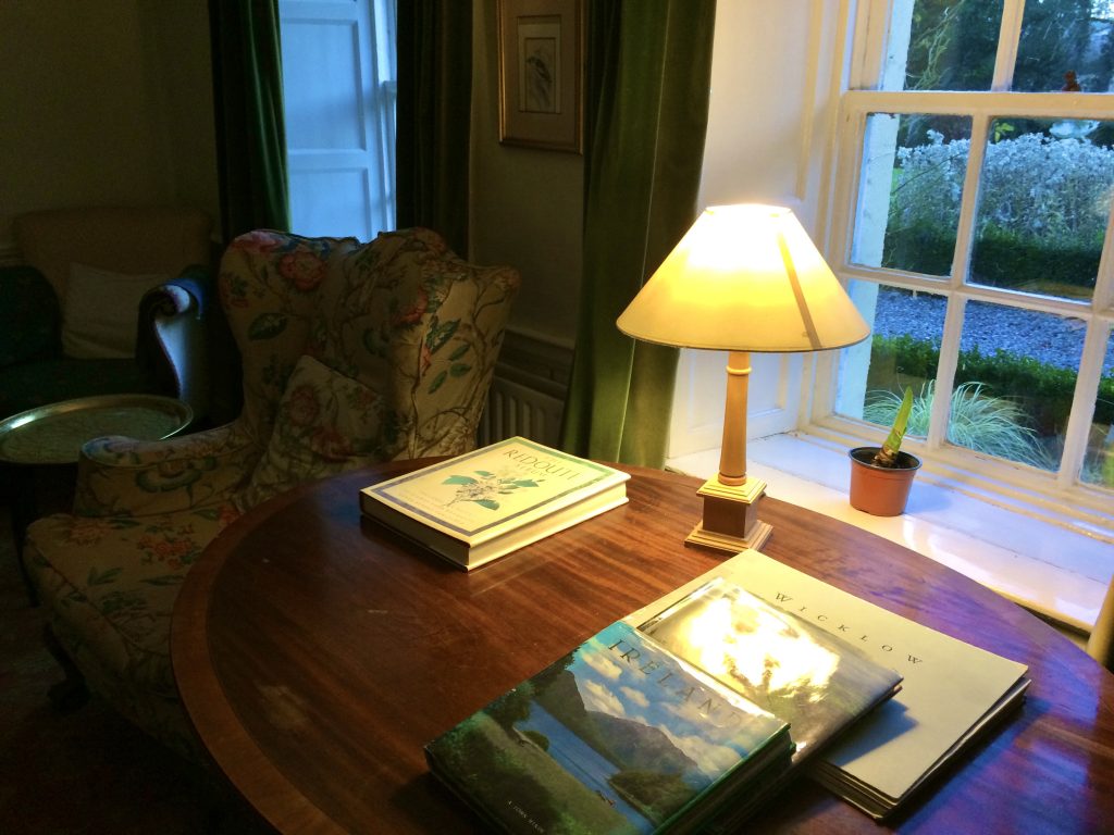 A lamp-lit desk in a cozy Irish study evokes the art of travel as a digital nomad. (Image © Joyce McGreevy)