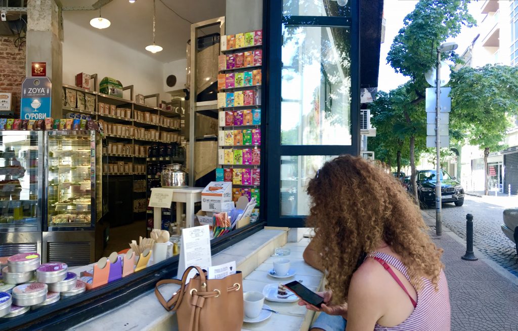 A woman using a smartphone in Sofia, Bulgaria counters cultural stereotypes about Eastern Europeans and technology. (Image © Joyce McGreevy)