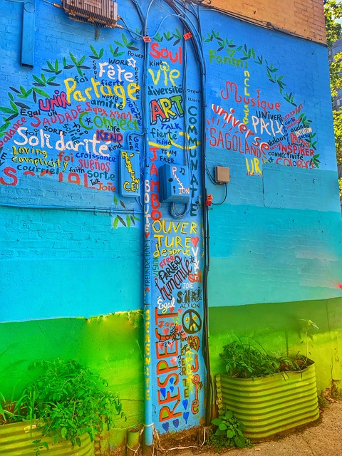 A community mural labeled with personal values that cross cultures reflects the idea that "carrying where you came from with you" can make a difference to others. (Image © Joyce McGreevy)