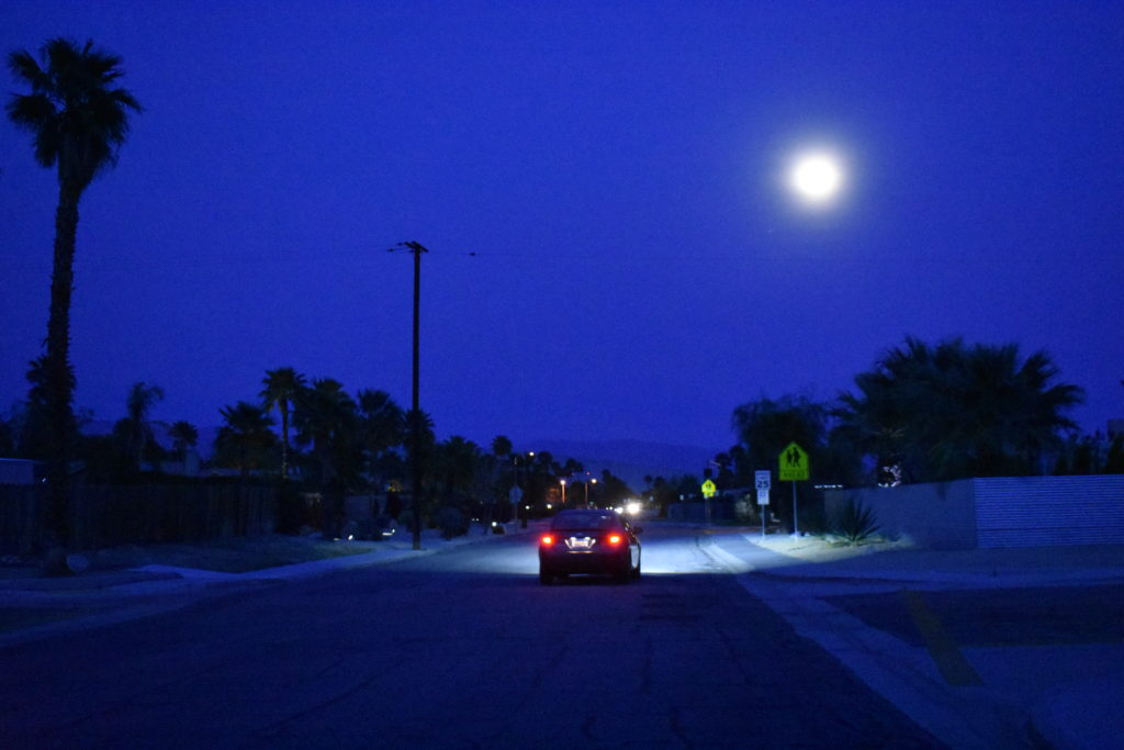 The full moon over a desert suburb in Palm Springs evokes the beauty of savoring summer. (Image @ Joyce McGreevy)