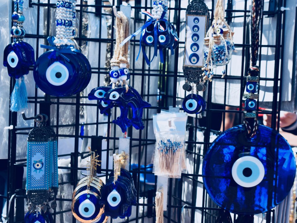 A display case of nazar boncuğu, blue glass eye beads, connect a Turkish Arts and Culture Festival in Monterey, California with the author’s memories of Istanbul. (Image © Joyce McGreevy)