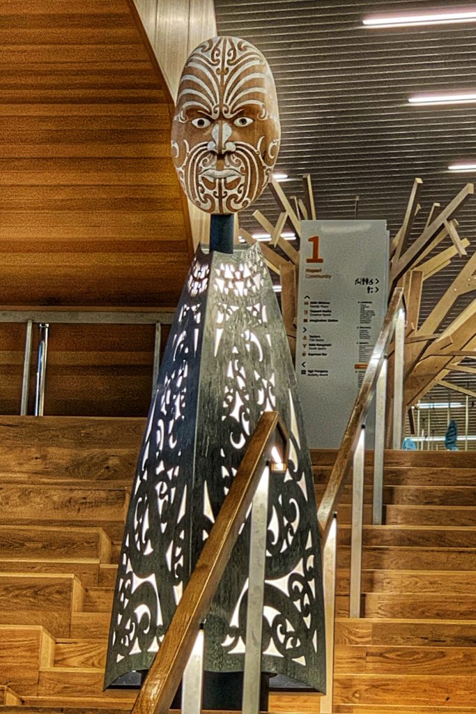 A statue of the Maori hero Tāwhaki at the Tauranga Library in Christchurch, New Zealand, inspires wanderlust to travel to public libraries, or library tourism, around the world. (Image © Joyce McGreevy)