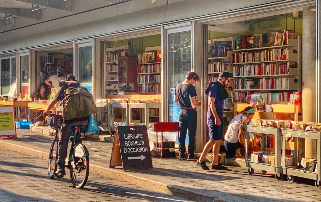 Allèe des bouquinistes, an open-air bookshop at the Grande Bibliothèque, Montréal, Canada inspires wanderlust to travel to public libraries, or library tourism, around the world. (Image © Joyce McGreevy)