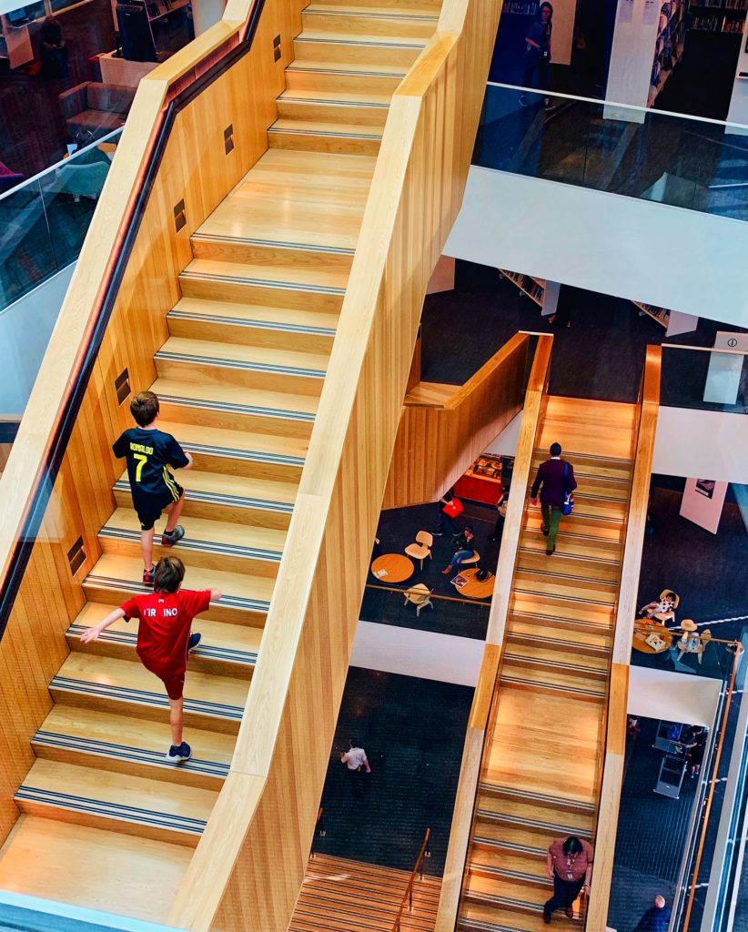 Staircases at the Tauranga Library in Christchurch, New Zealand, inspire wanderlust to travel to public libraries, or library tourism, around the world. (Image © Joyce McGreevy)
